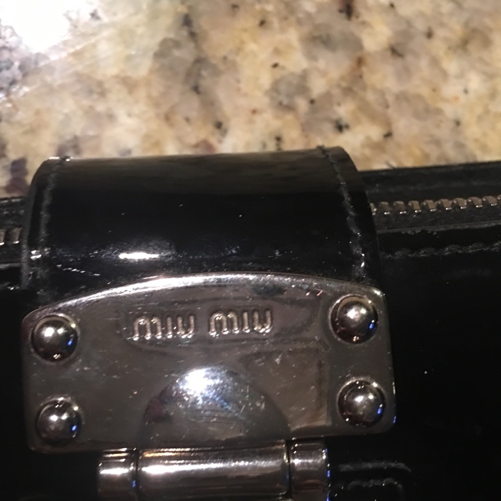 A black wallet. Designer Prada Miu Miu
